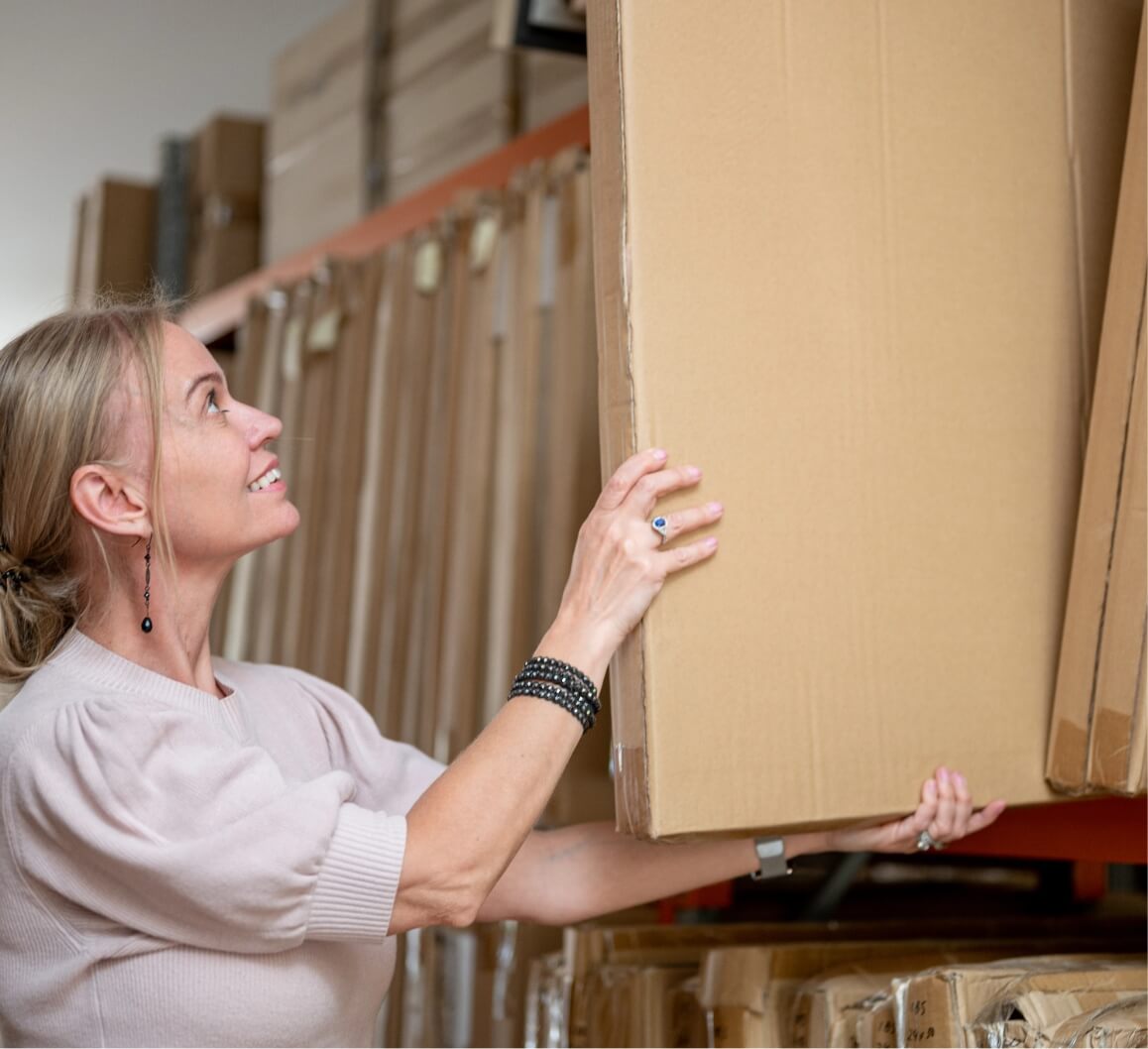 A woman gets a painting on storage